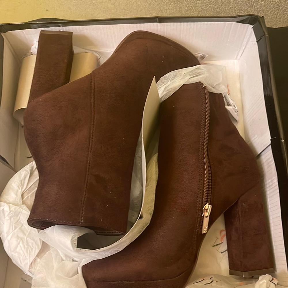 Brand new brown heeled boots. Never worn.